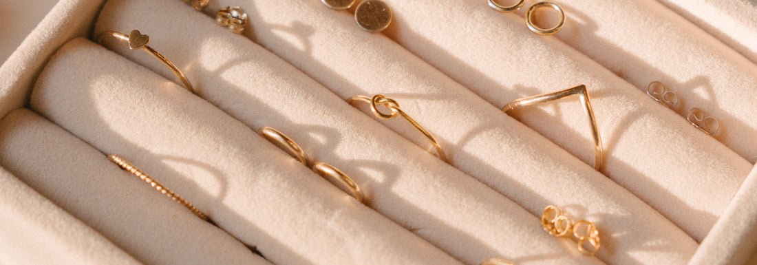 A jewelry box filled with gold rings.