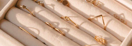 A jewelry box filled with gold rings.
