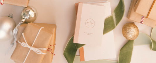 Wrapped boxes and small jewelry boxes with ornaments and ribbon strung around them