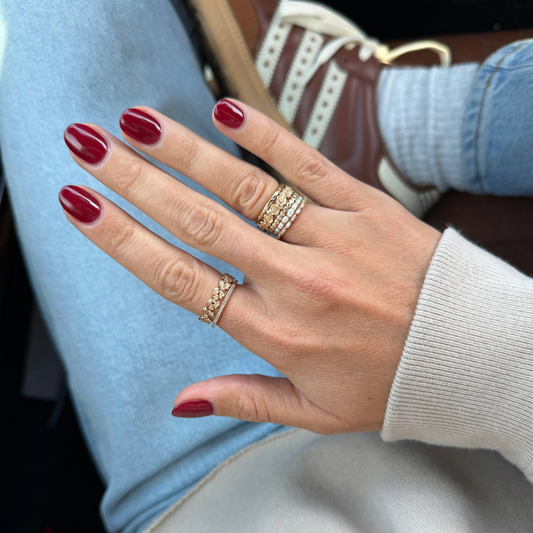Mary's ring stack featuring a CZ birth flower ring.
