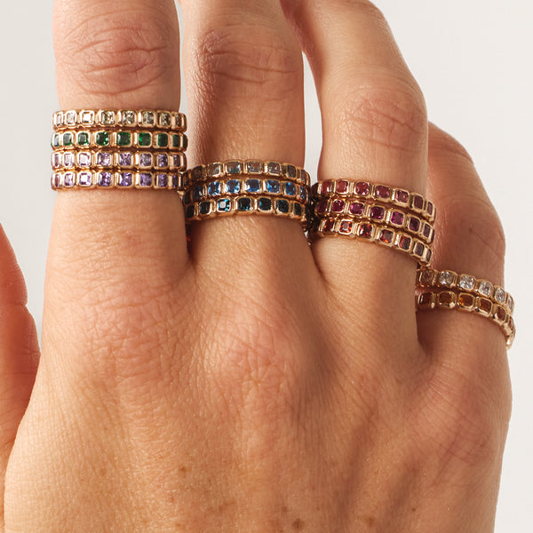 A model wearing stacked birthstone eternity rings.