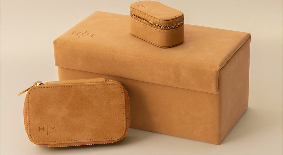 Three brown leather jewelry organizers in different sizes.