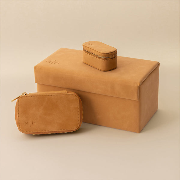 Three brown leather jewelry organizers in different sizes.
