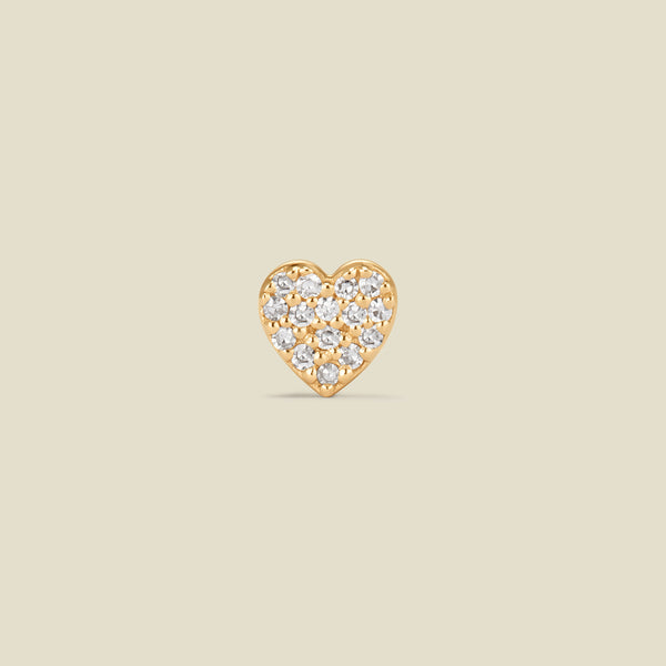 A 14k yellow-gold heart shaped earring stud, adorned with small, round-cut diamonds, set against a solid beige background.