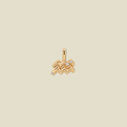 A gold pendant shaped like the Aquarius zodiac symbol, featuring three small clear gemstones, centered on a solid light beige background.