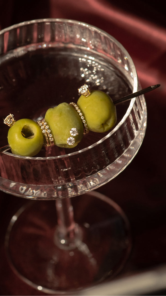 Signature Solitaire diamond jewelry styled with a martini glass.