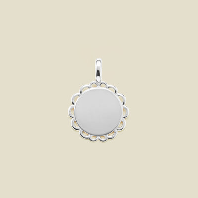 Silver round disc charm with scalloped edge detail