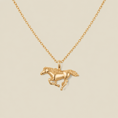 A gold chain necklace featuring a polished gold running horse pendant, displayed against a solid light beige background.