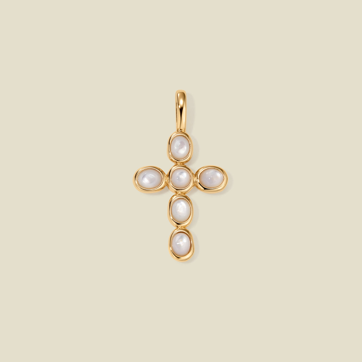 Gold cross pendant made of bezel-set pearl stones, suspended against a neutral background.