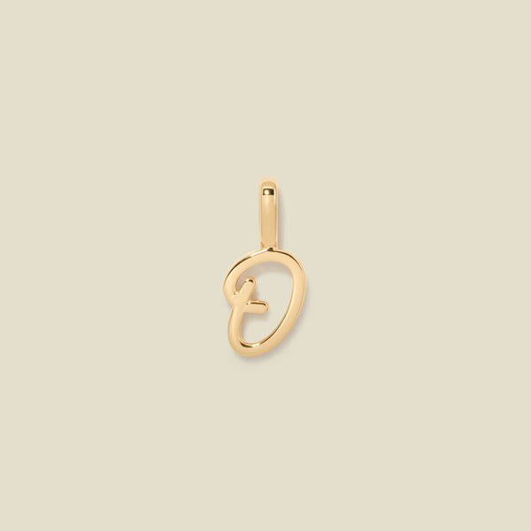 A polished gold initial pendant charm shaped like the letter 'O' in a cursive script, centered on a solid light beige background.