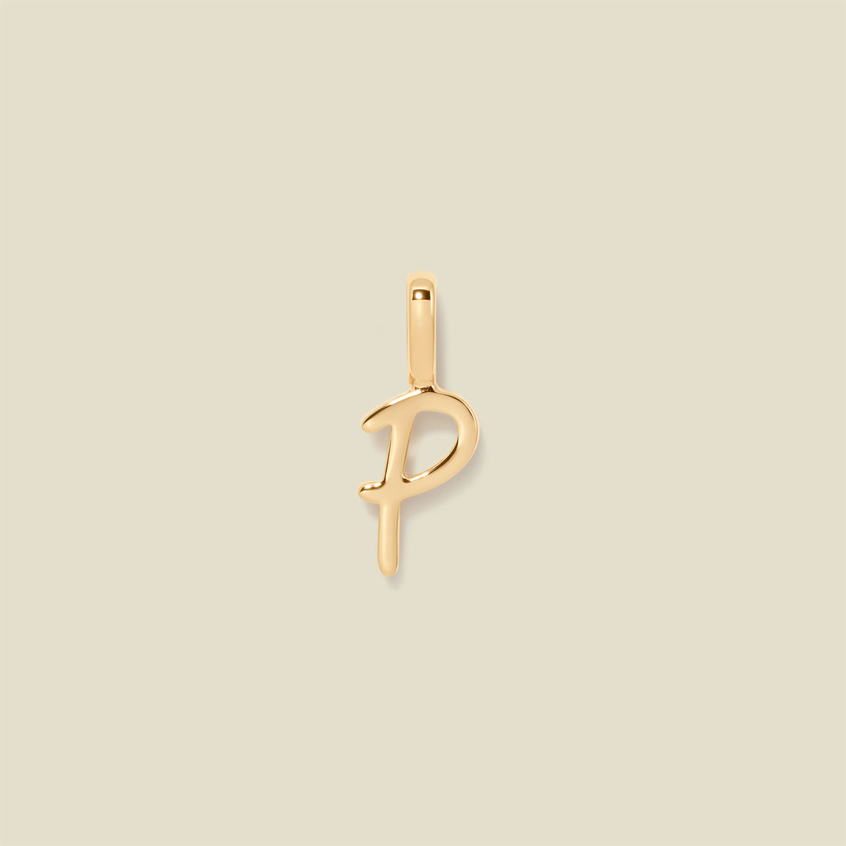 A polished gold initial pendant charm shaped like the letter 'P' in a cursive script, centered on a solid light beige background.