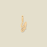 A gold charm letter Y against a neutral background.