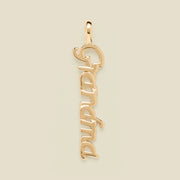 A polished gold script pendant spelling 'Grandma' vertically, shown on a solid light beige background.
