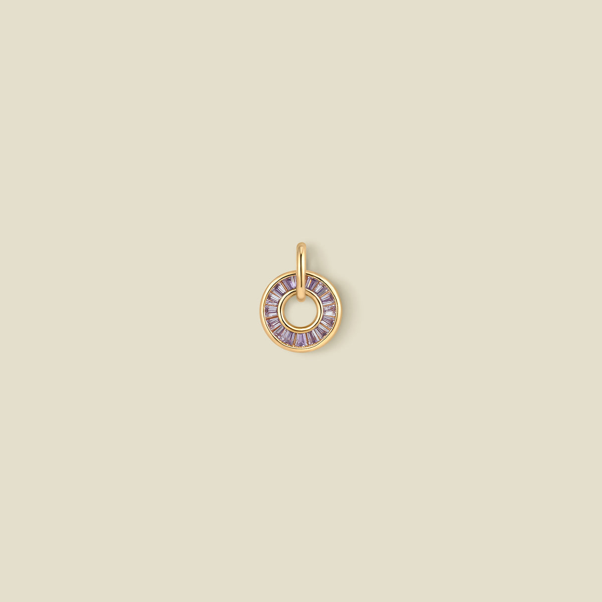 A circular pendant featuring light purple baguette-cut stones around a hollow center, displayed against a solid light beige background.