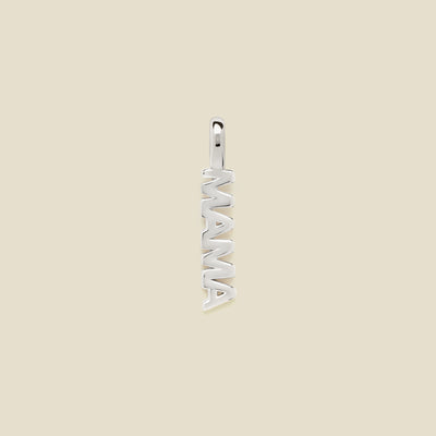 A vertical silver pendant spelling 'MAMA' in an openwork font, centered on a solid light beige background.