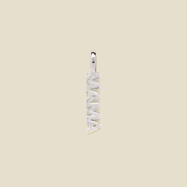 A vertical silver pendant spelling 'MAMA' in an openwork font, centered on a solid light beige background.