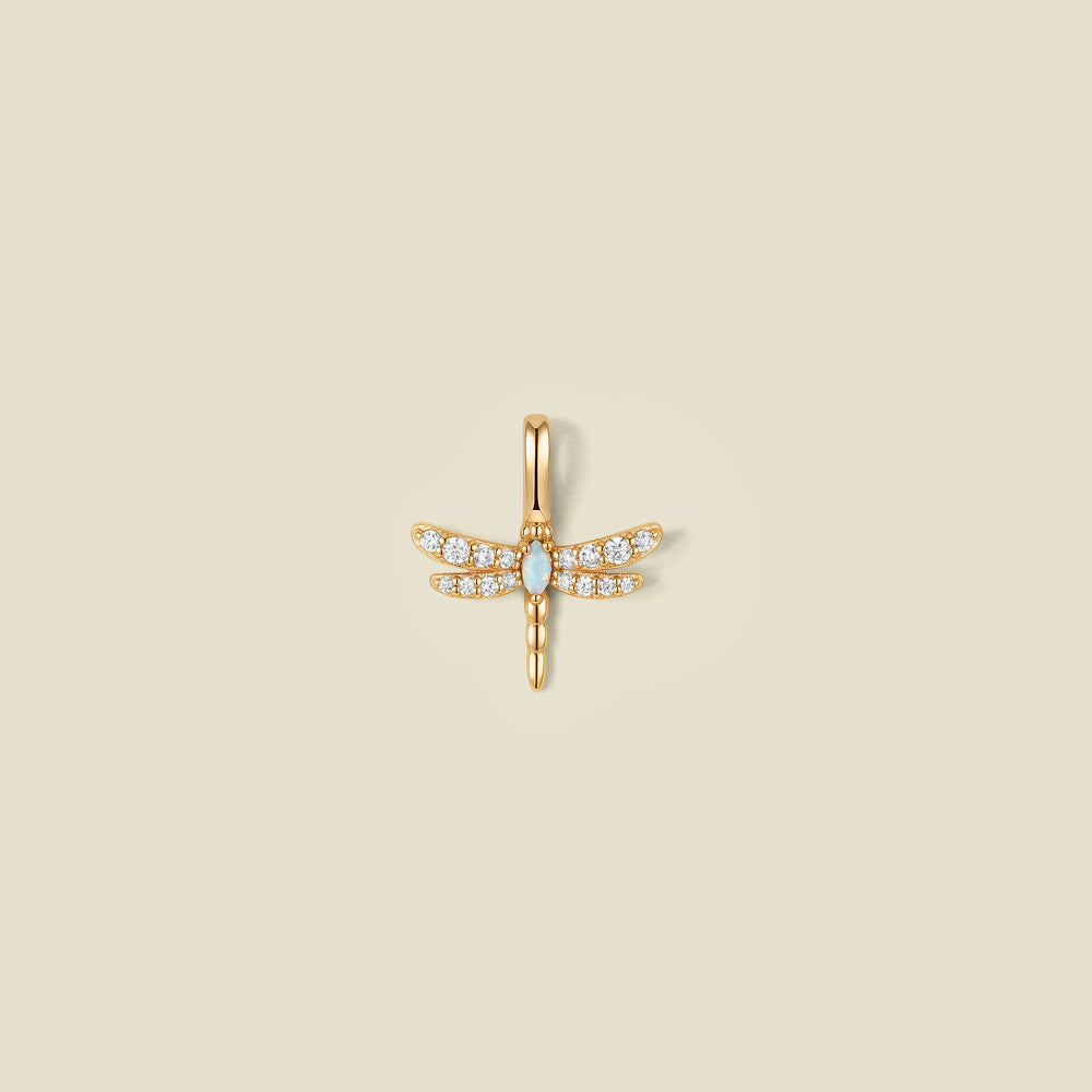 A gold dragonfly pendant charm with clear stones on the wings and an opal stone in the center.
