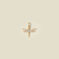 A gold dragonfly pendant charm with clear stones on the wings and an opal stone in the center.