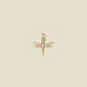 A gold dragonfly pendant charm with clear stones on the wings and an opal stone in the center.