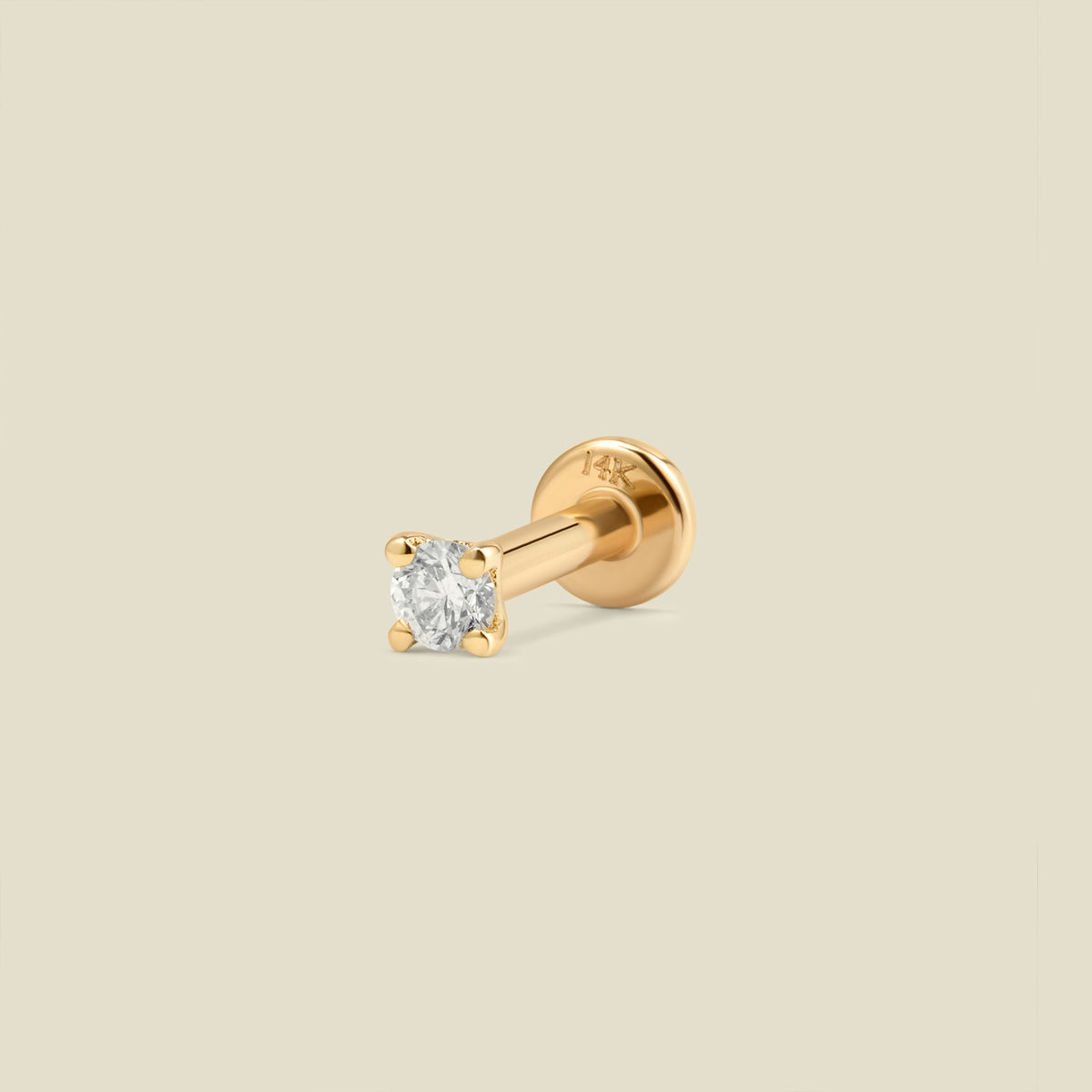 A single gold solitaire stud earring featuring a square-cut clear diamond in a four-prong setting, shown on a solid light beige background.