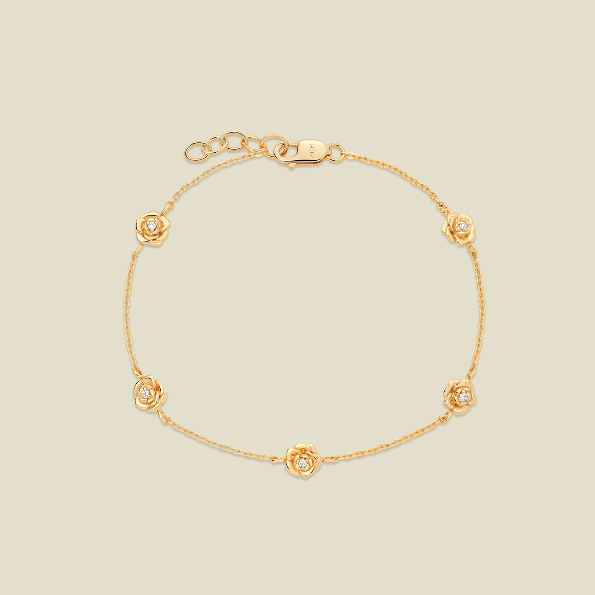A delicate gold chain bracelet featuring five ornate, textured gold peony charms with small clear stones, arranged in a circle on a light beige background.