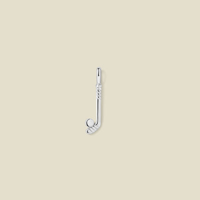 A silver charm shaped like a hockey stick, featuring a straight shaft with a textured wrap design and a circular clubhead with a puck on top, shown on a solid beige background.