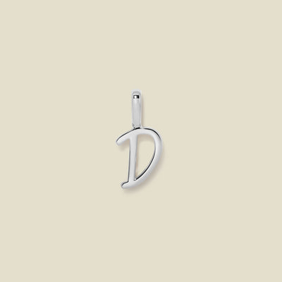 A polished silver initial pendant charm shaped like the letter 'D' in a cursive script, centered on a solid light beige background.