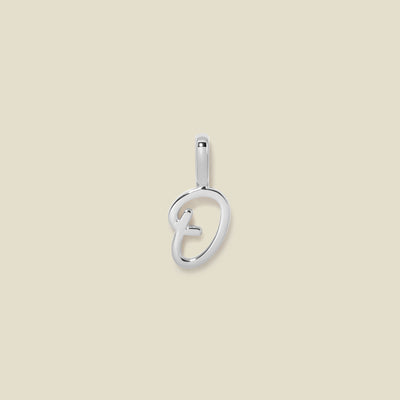 A polished silver initial pendant charm shaped like the letter 'O' in a cursive script, centered on a solid light beige background.