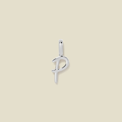 A polished silver initial pendant charm shaped like the letter 'P' in a cursive script, centered on a solid light beige background.