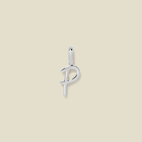 A polished silver initial pendant charm shaped like the letter 'P' in a cursive script, centered on a solid light beige background.