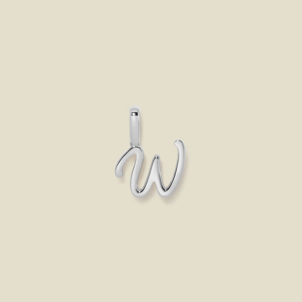A polished silver initial pendant charm shaped like the letter 'W' in a cursive script, centered on a solid light beige background.