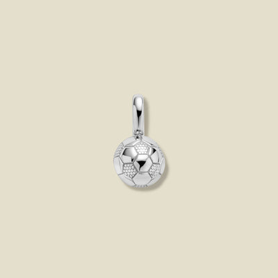 Silver pendant shaped like a soccer ball on a beige background