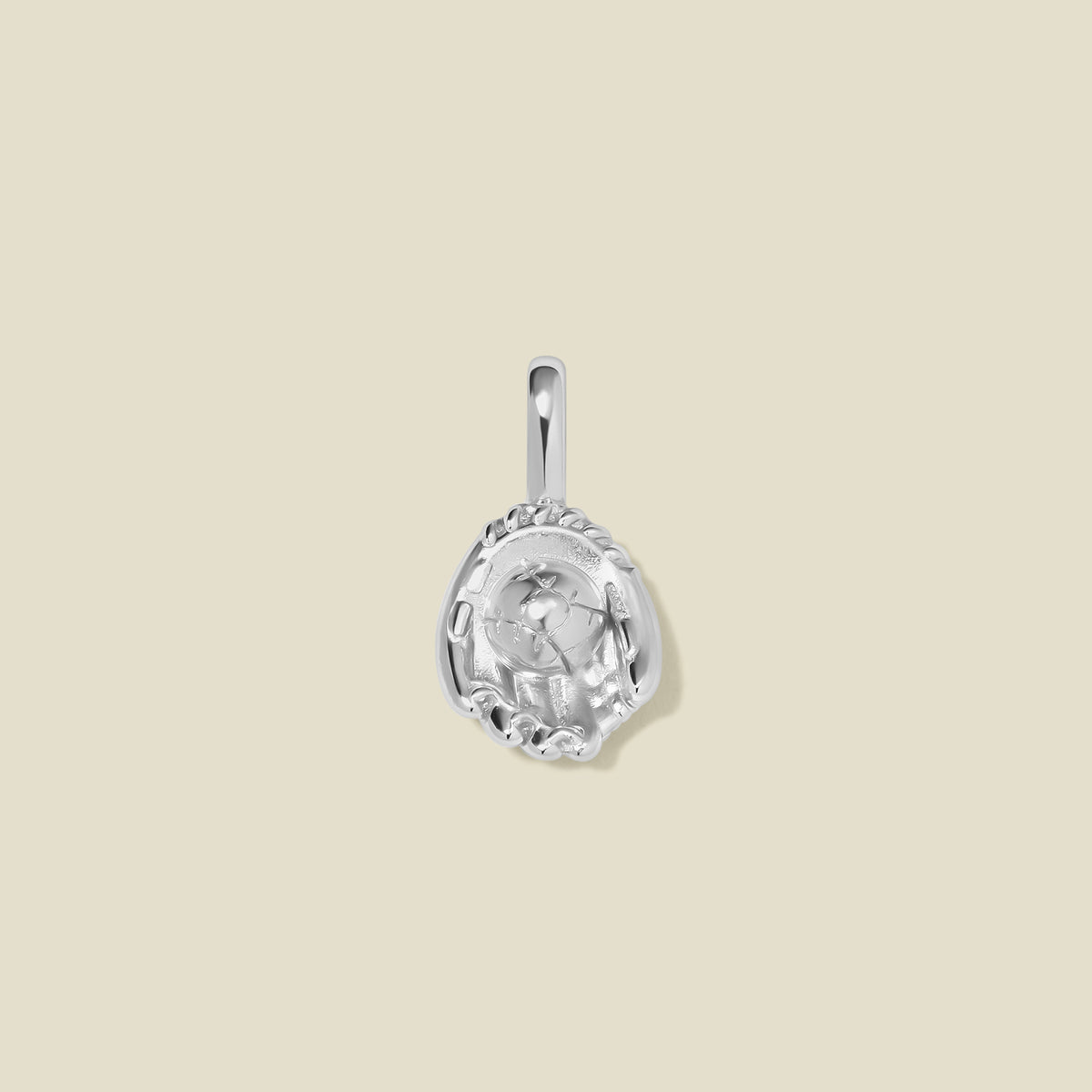 A silver baseball mitt charm with seam details, set against a solid beige background.