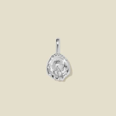A silver baseball mitt charm with seam details, set against a solid beige background.