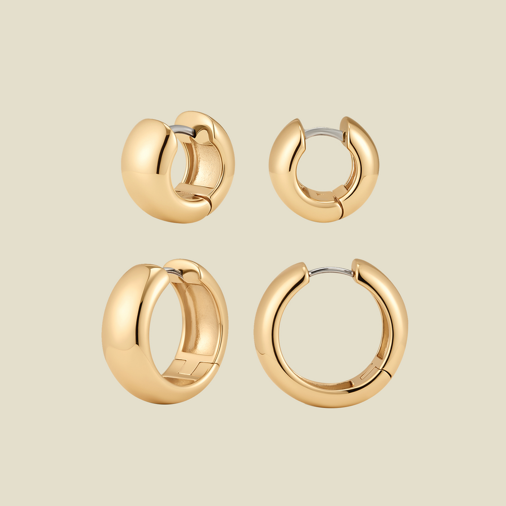 Two sets of polished gold huggie hoop earrings in two sizes, shown from different angles on a light beige background.