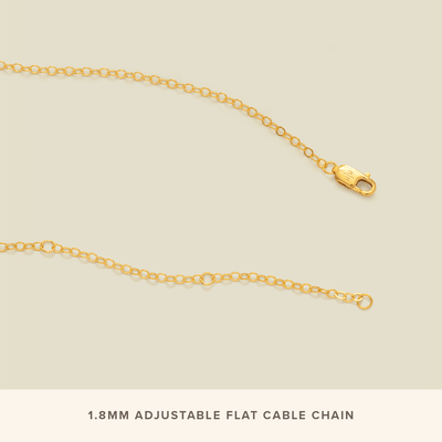 The end of a delicate gold chain necklace unclasped, showcasing the lobster clasp and three jump rings at different lengths to latch it to.