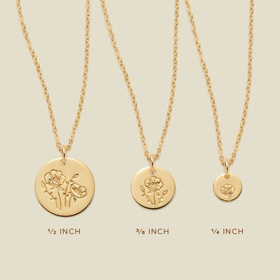 Three gold pendant necklaces, each with a different size of round flat disc and engraved with varying poppy flower designs. Below the necklaces there is the text '1/2 INCH', '3/8 INCH', and '1/4 INCH'.