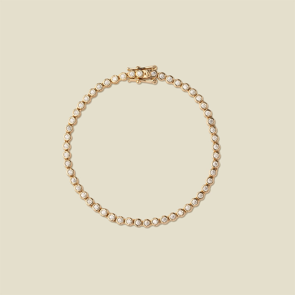 A gold tennis bracelet with clear round-cut gemstones, arranged in a circular shape on a solid beige background.