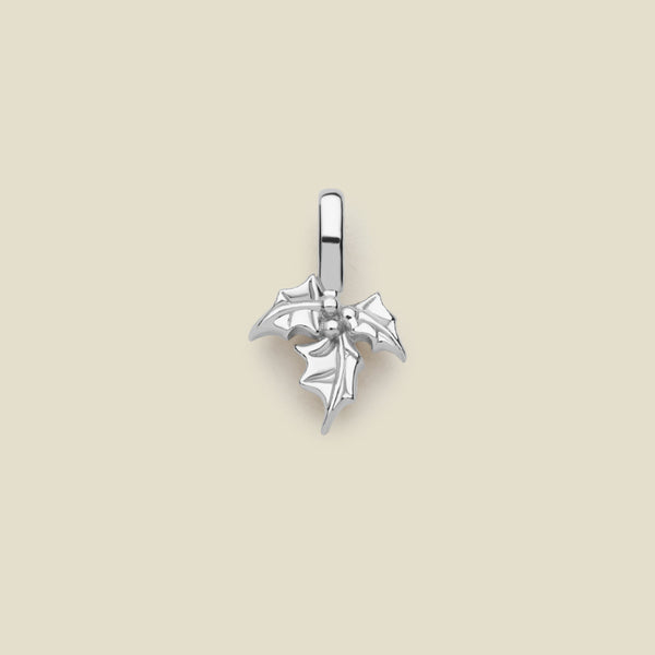 A silver charm in the shape of a holly leaf design, with a loop for attachment at the top.