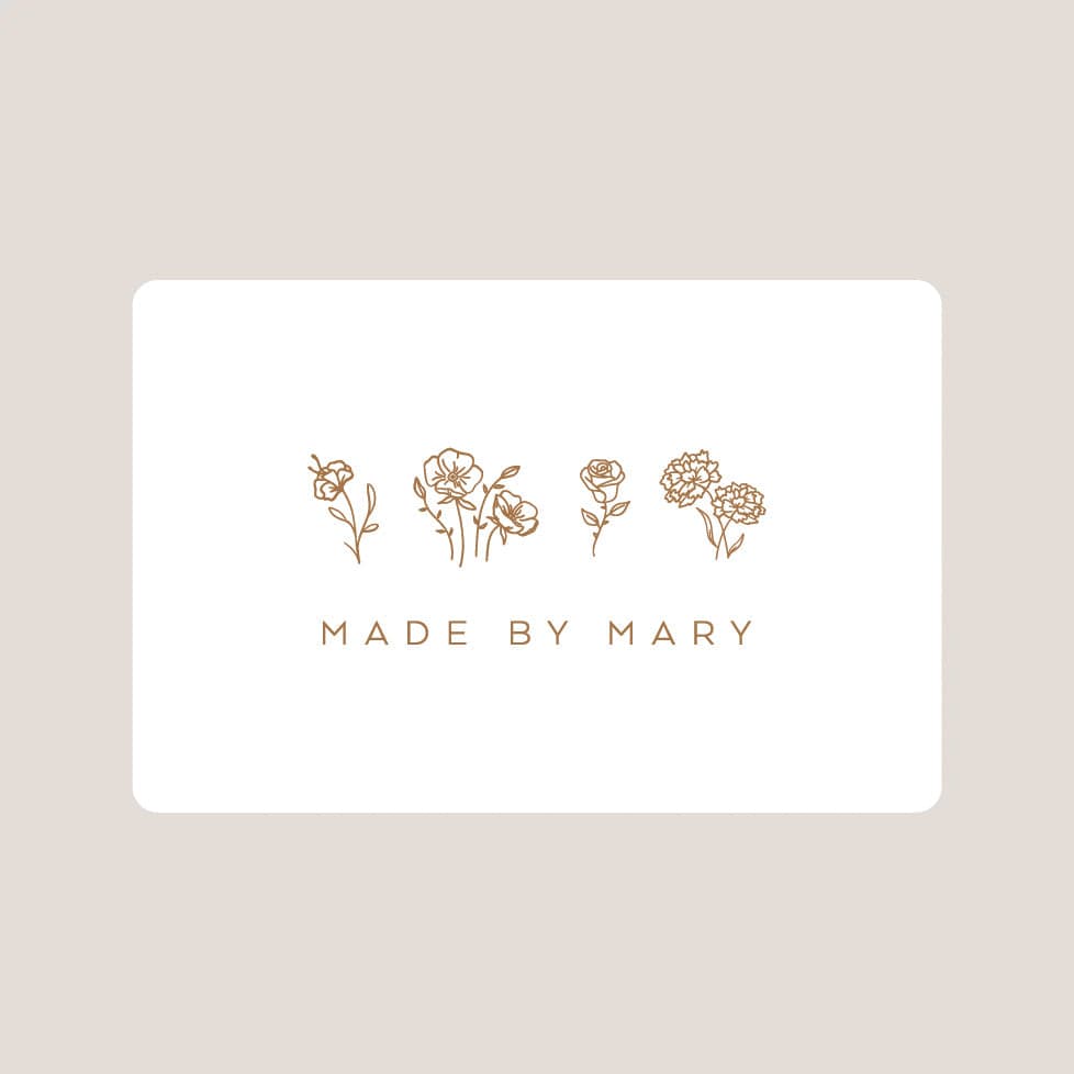 White card with gold floral illustrations and 'MADE BY MARY' text on a beige background