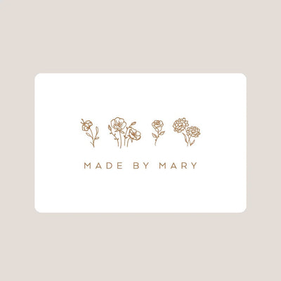 White card with gold floral illustrations and 'MADE BY MARY' text on a beige background