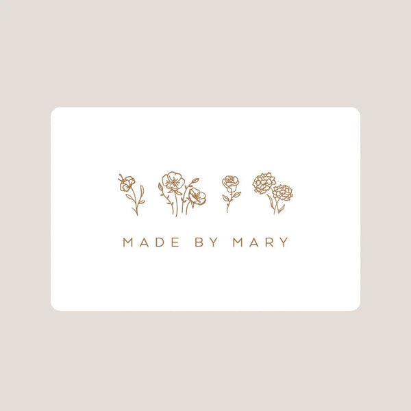 White card with gold floral illustrations and 'MADE BY MARY' text on a beige background
