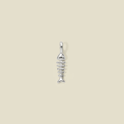 A silver charm in the shape of a fishbone with a small clear zirconia in the eye position, displayed against a light background.
