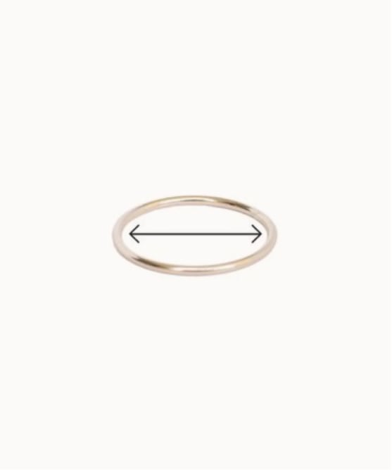 A thin silver ring with arrows pointing across the inside diameter, showing how to accurately measure your rings.