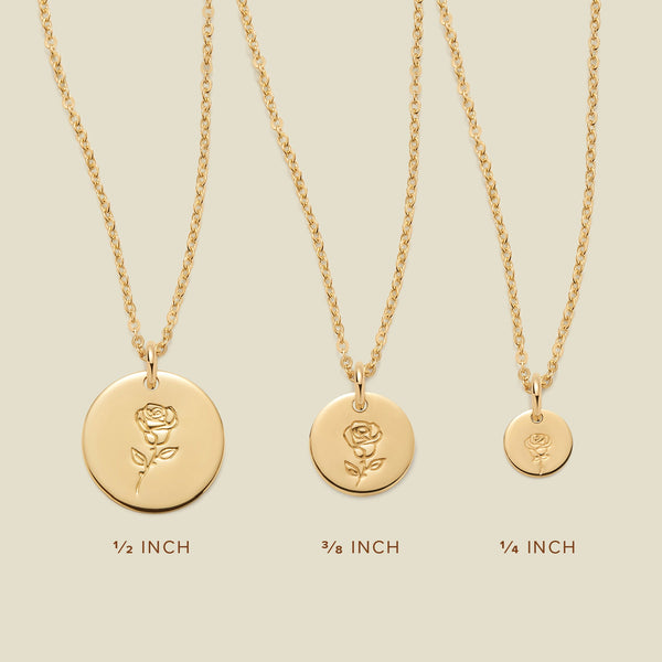 Three gold pendant necklaces, each with a different size of round flat disc and engraved with varying rose flower designs. Below the necklaces there is the text '1/2 INCH', '3/8 INCH', and '1/4 INCH'.