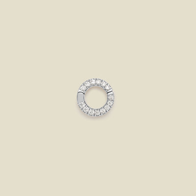 A small silver circular ring attachment embellished with clear pavé stones, shown on a solid beige background.