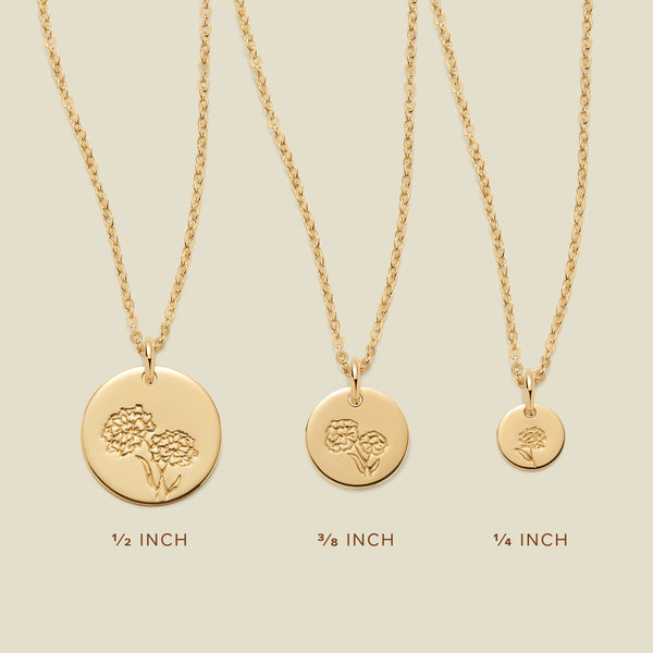 Three gold pendant necklaces, each with a different size of round flat disc and engraved with varying marigold flower designs. Below the necklaces there is the text '1/2 INCH', '3/8 INCH', and '1/4 INCH'.