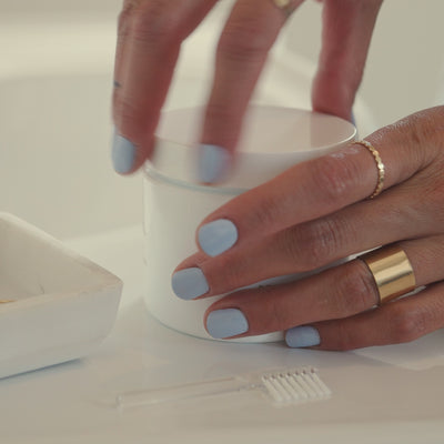video of model walking through how to use restore jewelry cleaner liquid and brush cleaning tool on gold hoop earrings