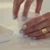 video of model walking through how to use restore jewelry cleaner liquid and brush cleaning tool on gold hoop earrings