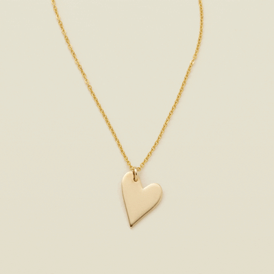 A gif of a delicate gold pendant chain necklace with a flat gold heart charm, starting blank then being engraved with the letter 'M'. From there, multiple smaller engraved heart charms are added one by one, each with a different initial.
